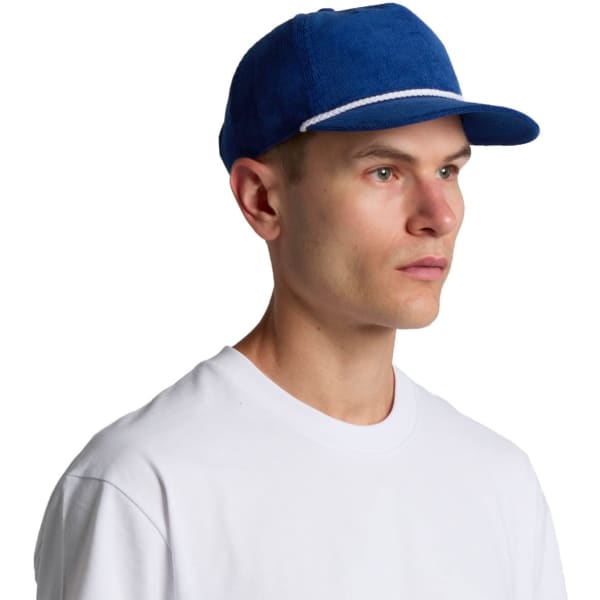 A blue corduroy cap featuring a flat brim and an understated design, including a logo on the front.