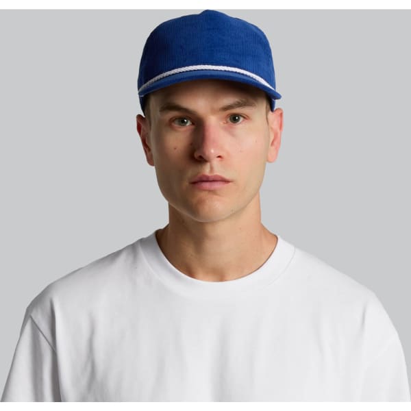 A blue cap with a white stripe, worn by a person in a plain white t-shirt. The cap also features a logo.