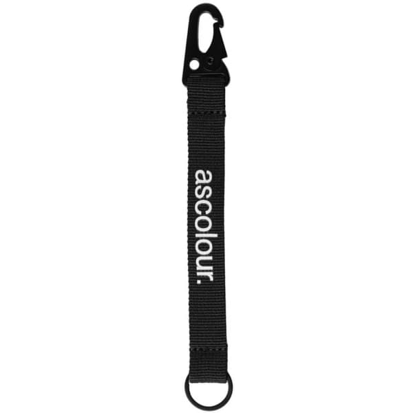 A black keychain with a clip and loop design, featuring a branding logo.