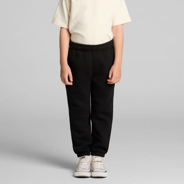 Youth Relax Track Pants in black, featuring an elastic waistband and a relaxed fit, paired with a plain t-shirt and sneakers.