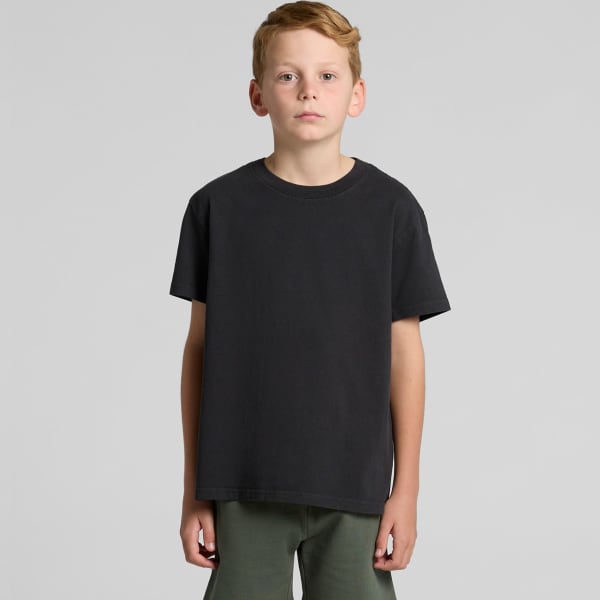 A youth heavy faded tee in black, displayed on a model against a plain background. The shirt features a logo.