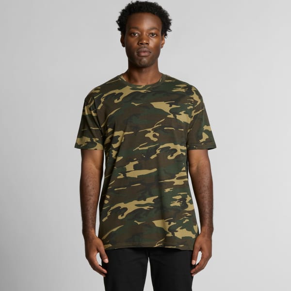 A green and brown camouflage T-shirt featuring a logo, displayed on a model against a neutral background.
