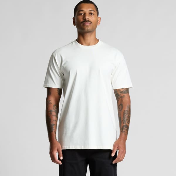 A plain white organic T-shirt displayed on a male model with tattoos, featuring short sleeves and a casual fit.