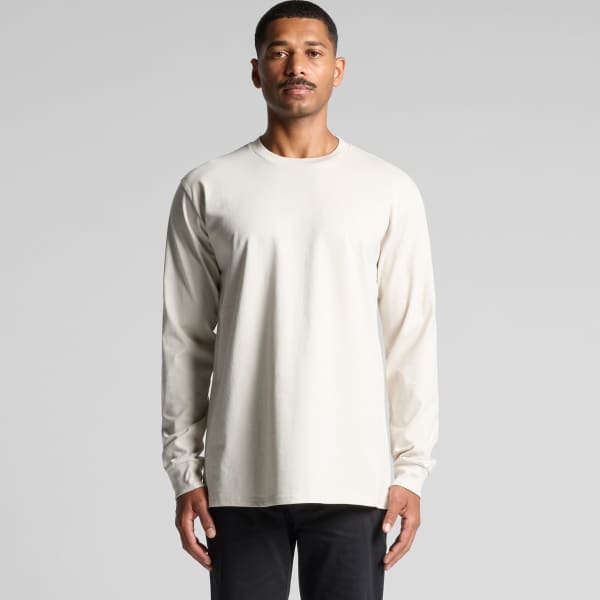 A long-sleeve tee in a light beige colour, featuring a simple design and a logo on the shirt.