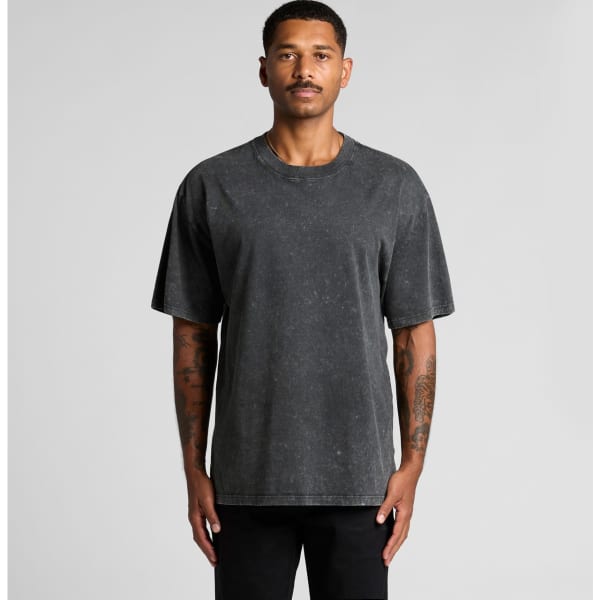 A man wearing a stone wash heavy tee in dark grey, featuring a relaxed fit and short sleeves.