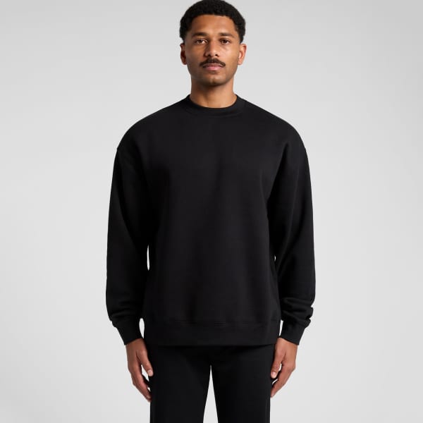 A black sweater with a relaxed fit and long sleeves. The garment has a simple design and features a logo.