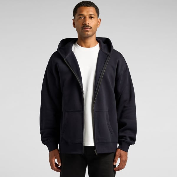 A navy zip-up hoodie with a hood and front pockets, worn by a model. Includes a logo on the garment.