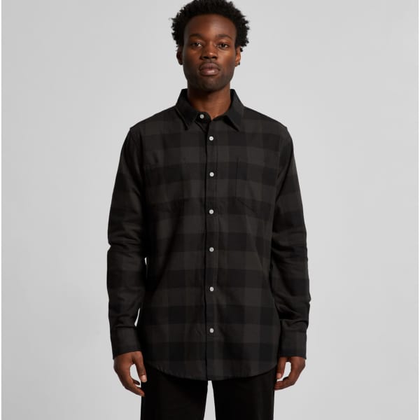 A button-up check shirt in black with a classic collar and long sleeves, featuring a front pocket and a logo.