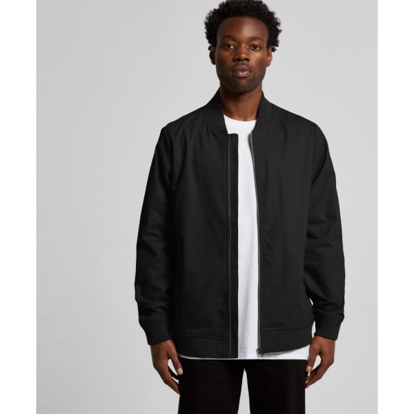 A black bomber jacket worn by a model, featuring a zip front and ribbed cuffs, with a logo visible.