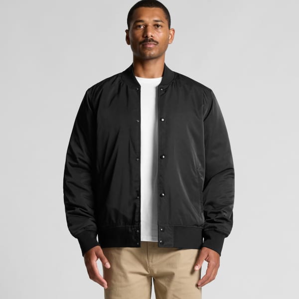 A black bomber jacket featuring a classic design and a logo on the chest, paired with a white T-shirt and neutral trousers.