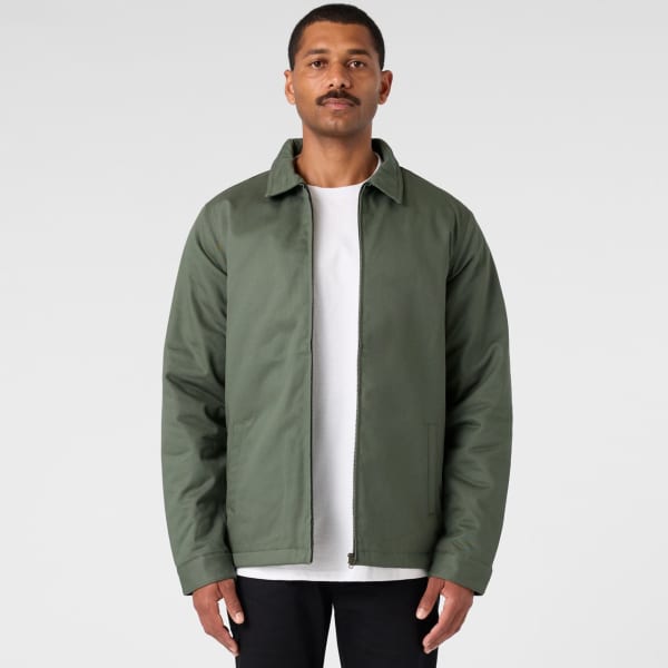 A green service jacket with a collared neck and a zip front, worn over a white t-shirt, displayed against a neutral background.