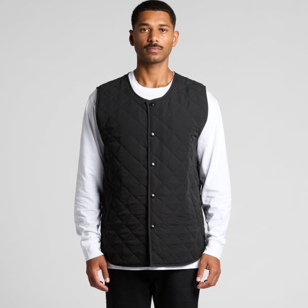A black quilted vest with a snap button front, displayed on a model wearing a white shirt underneath.