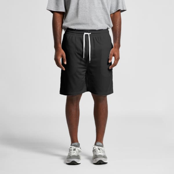 Black sports shorts with a drawstring waist, worn by a person in a grey t-shirt and grey trainers.