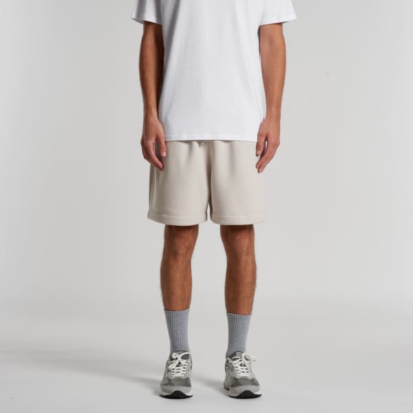 Relax Track Shorts in light beige, featuring a relaxed fit, worn with a white t-shirt and grey socks.