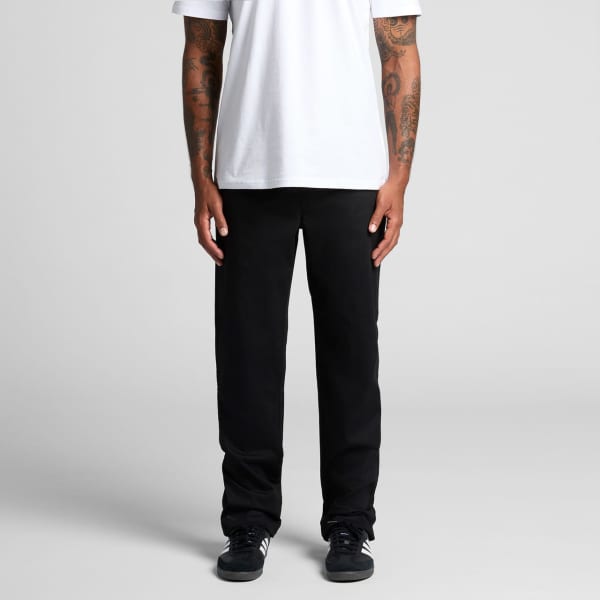 Straight elastic pants in black worn by a person standing. Features slight taper at the ankles and a simple design.