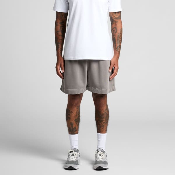 Relaxed grey track shorts with a casual fit, featuring an elastic waistband and a logo. Pair styled with a white T-shirt.