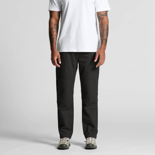 Canvas pants in black, featuring a straight leg design and a logo on the pocket, modelled by a person.
