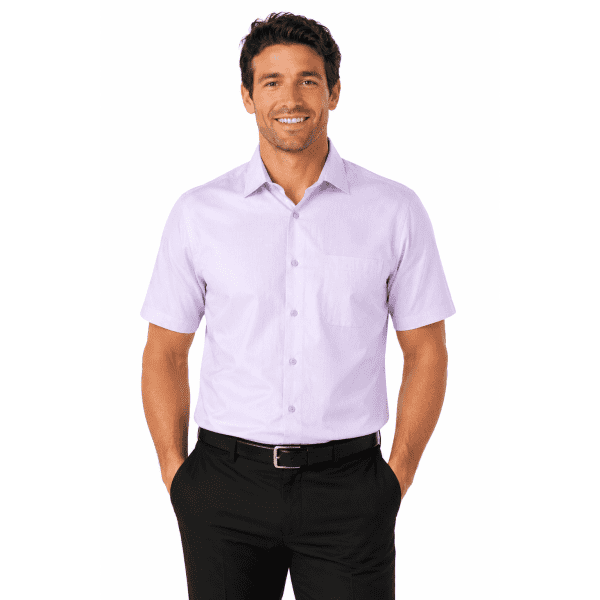 A short-sleeve men's shirt in light purple, featuring a pocket and a logo, modelled by a smiling man.