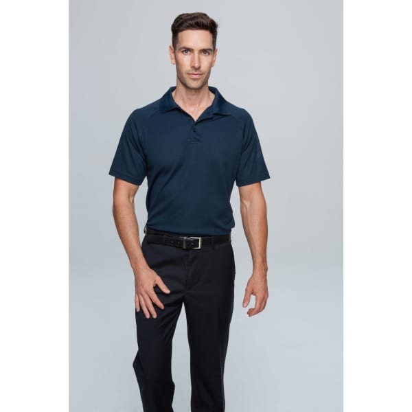 A man wearing a navy polo shirt paired with black trousers. The shirt features a logo on the chest.