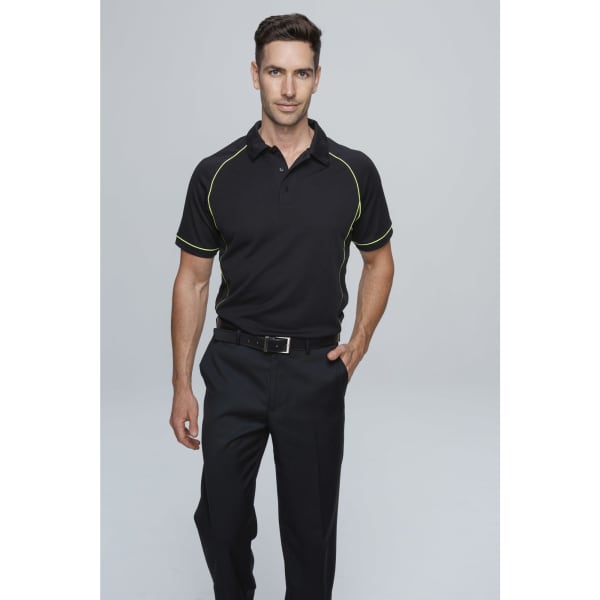 A man wearing a black polo shirt with yellow accents, paired with dark trousers. The shirt features a logo.