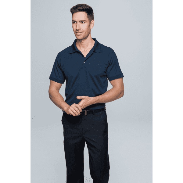 A man wearing a navy blue polo shirt with a logo, paired with black trousers against a plain background.