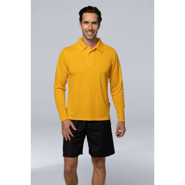 A man wearing a long-sleeve, bright yellow polo shirt paired with black shorts. The shirt features a logo.
