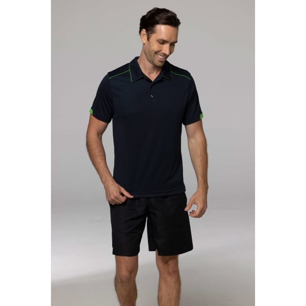 A man wearing a navy polo shirt with green accents, paired with black shorts. The polo has a logo on it.