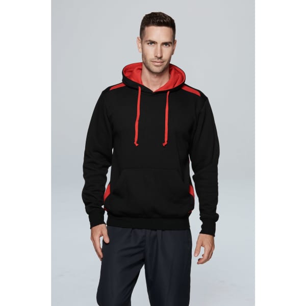 A black hoodie with red accents, featuring a front pocket and drawstring hood, displayed by a model.
