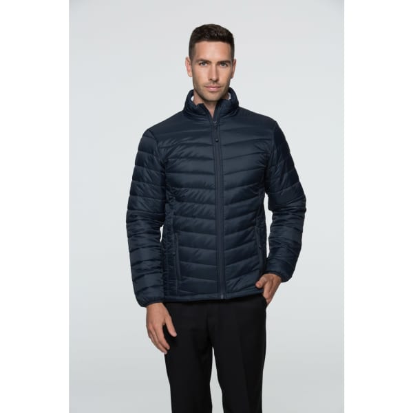 A dark navy men's jacket with a zip front and a quilted design, modelled by a man. The jacket features a raised collar.
