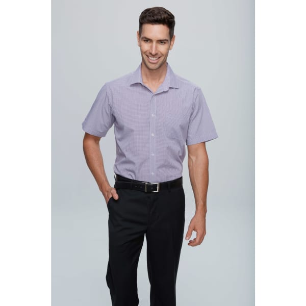 A short-sleeve button-up shirt in purple with a subtle pattern, paired with black trousers. Features a logo.