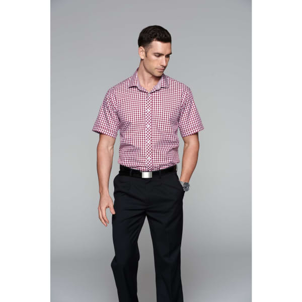 A short sleeve button-up shirt in red and white check pattern, paired with black trousers, modelled by a man.