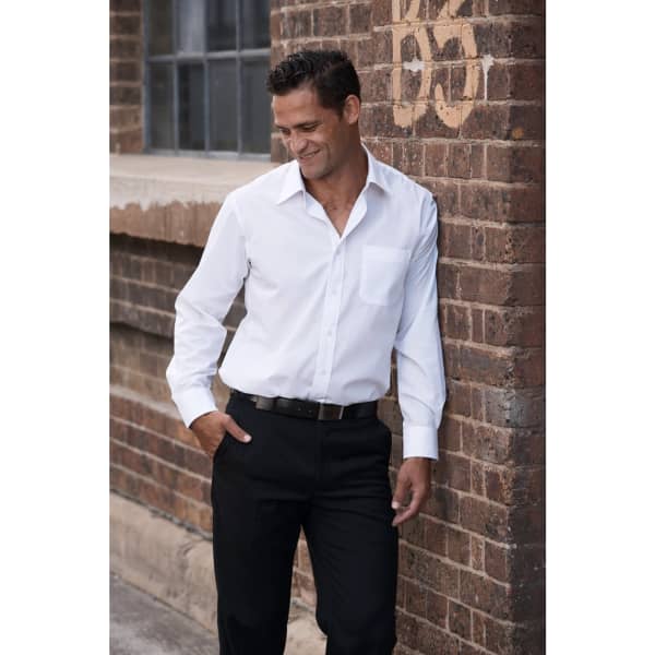 A long-sleeve white button-up shirt, styled with black trousers, featuring a pocket and a logo.