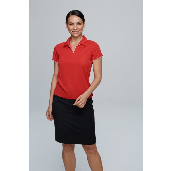 A red polo shirt with a white trim, paired with a black skirt, displayed by a smiling woman. It features a logo.