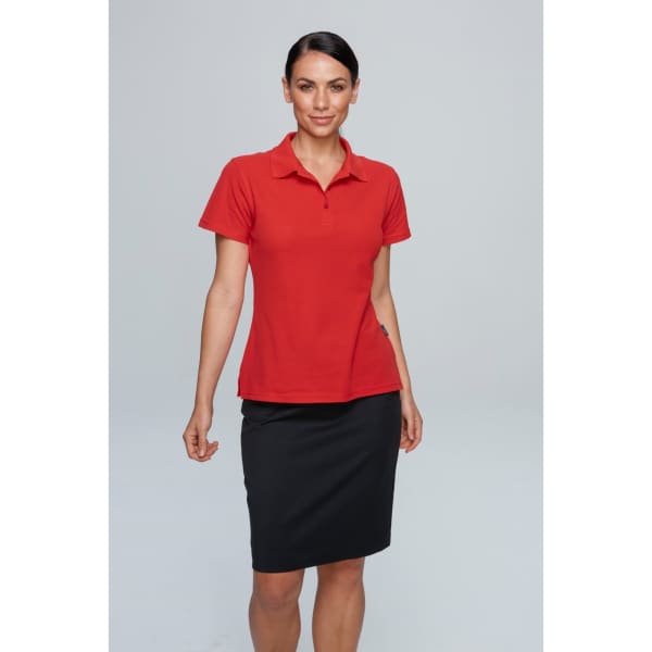 A red polo shirt modelled by a woman, paired with a black skirt. The shirt has a logo on it.