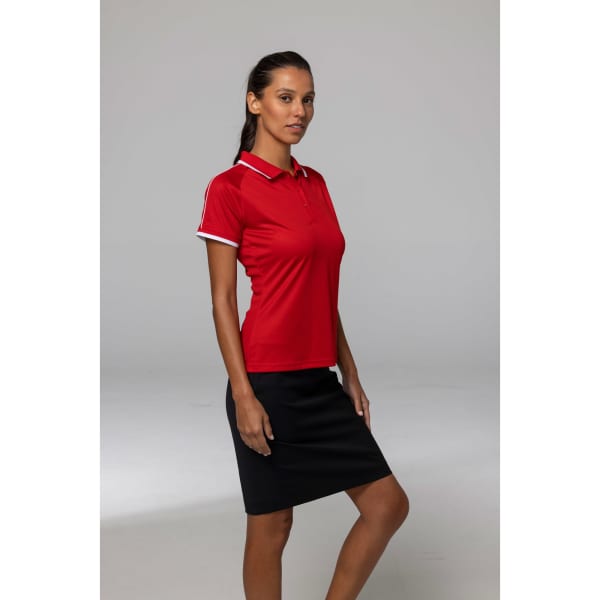 A red polo shirt with white detailing, modelled by a woman, paired with a black skirt. The shirt features a logo.