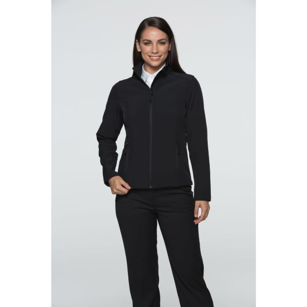 A woman wearing a black soft shell jacket, featuring a zippered front and two side pockets. The jacket has a logo.