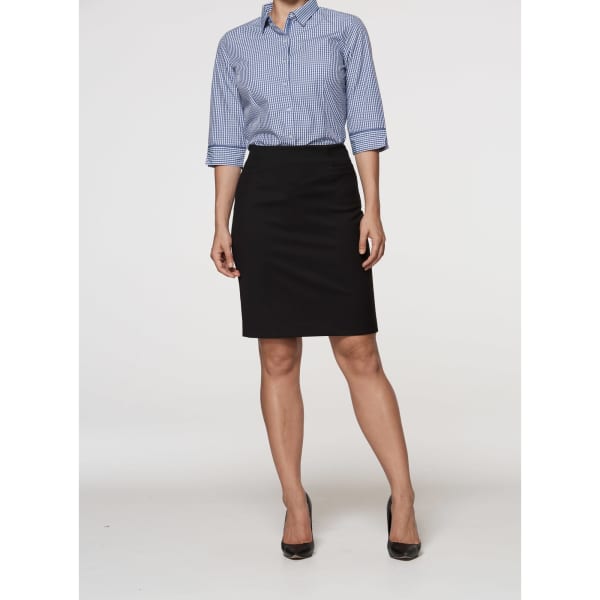 A black knee-length skirt worn with a checkered shirt and black heels, featuring a logo on the waistband.