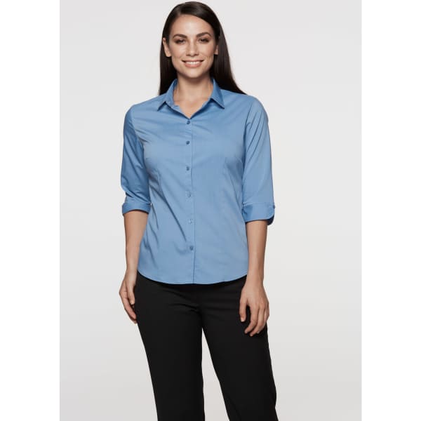A light blue button-up shirt with 3/4 sleeves, featuring a collar and a logo on the chest.