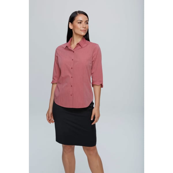A button-up shirt in a soft pink hue with 3/4 sleeves, paired with a black skirt. Features a logo.