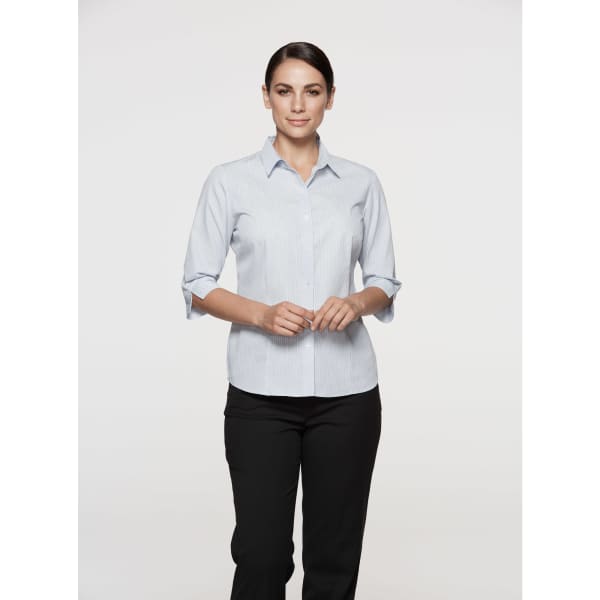 A button-up shirt in light blue with 3/4 sleeves, featuring a subtle stripe pattern and a logo.