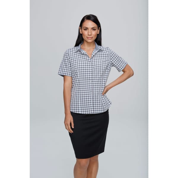 A short-sleeve button-up shirt in a grey and white checked pattern, displayed on a model. The design includes a logo.