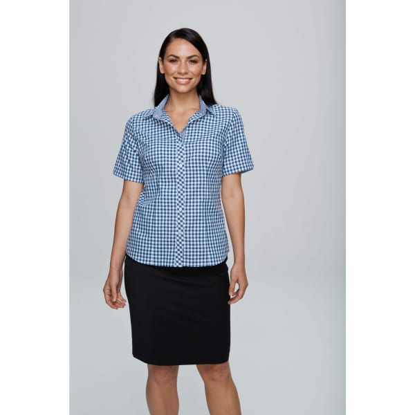 A short-sleeve blue and white checkered button-up shirt, featuring a collar and a logo. Worn with a black skirt.