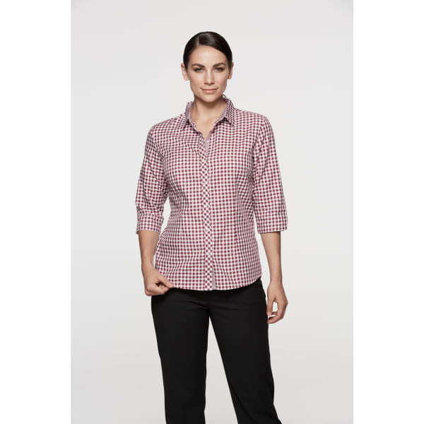 A button-up shirt with 3/4 sleeves in a red and white gingham pattern. Features a branding logo.