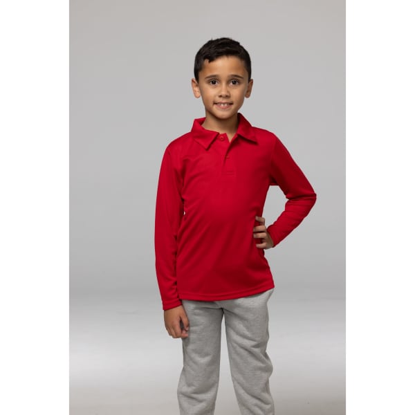 A child wearing a bright red long-sleeved polo shirt paired with grey pants, posing confidently.