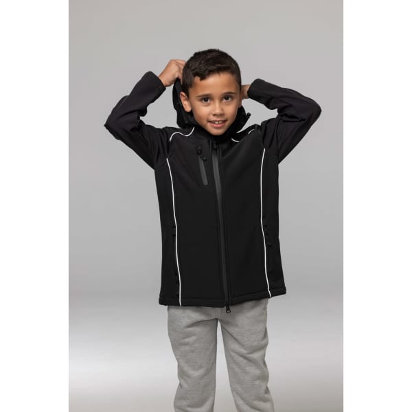 A black jacket with a hood displayed on a child, featuring white accents and a logo. The child is smiling and adjusting the hood.