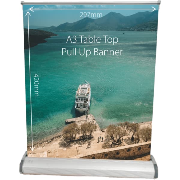 A table top pull-up banner featuring an image of a boat by the water, with mountains in the background. It has a logo.