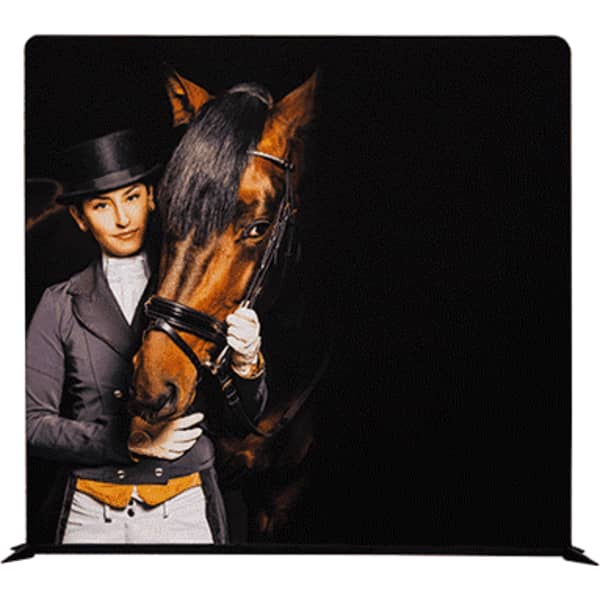 A tension fabric display featuring a person in equestrian attire with a horse against a dark background.