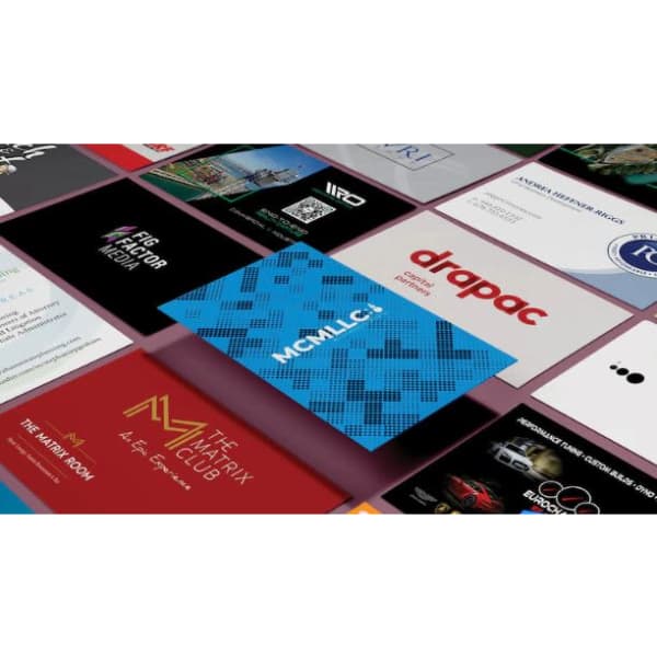 A collection of various business cards featuring different designs, colours, and logos displayed on a flat surface.