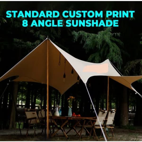 A tan canopy with eight angles set up outdoors among trees, featuring poles and hanging lights.