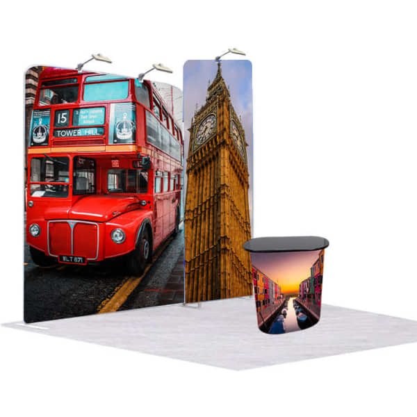 A tension fabric display featuring a red double-decker bus, Big Ben, and a modern table with a printed design.